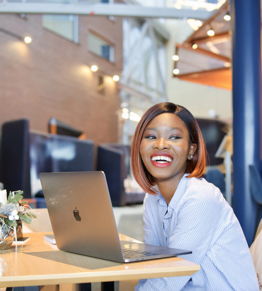 Smiling business owner working on her laptop