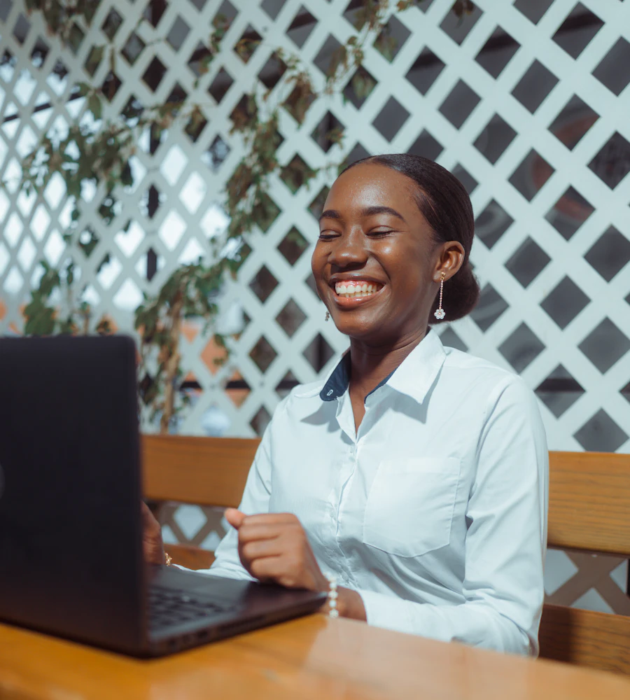 Young woman smiling while learning on her laptop
